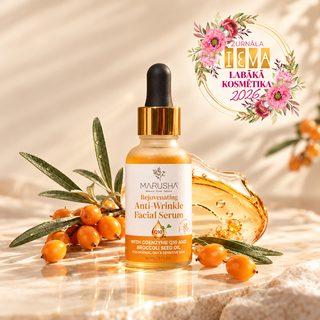 A bottle of Marusha Rejuvenating Anti-Wrinkle Facial Serum is displayed on a reflective marble surface, surrounded by fresh sea buckthorn berries, green leaves, and a gold dropper cap. A pink and gold award badge for 'Tea Labák Kosmétika 2026' is positioned in the upper right corner.