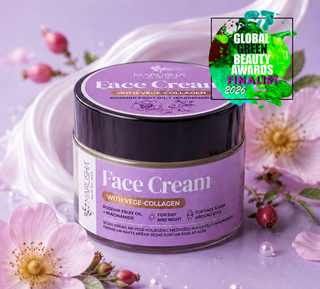 A jar of Marushia Face Cream with Vege-Collagen, featuring a lavender and purple label with a black lid, styled with pink flowers and pearls on a lavender background. A green and purple 'Global Beauty Awards Finalist 2026' badge is in the top right corner.