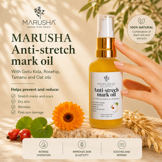 A bottle of MARUSHA Anti-stretch mark oil is held by a hand against a warm beige background with decorative text, a sunflower, tomatoes, and wheat. The bottle has a gold pump and white cap, and the label reads 'MARUSHA Anti-stretch mark oil' with ingredients listed on the left.