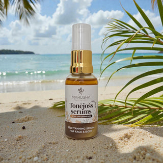 Marusha Tonejoss serums bottle on a sandy beach with palm leaves and ocean in the background