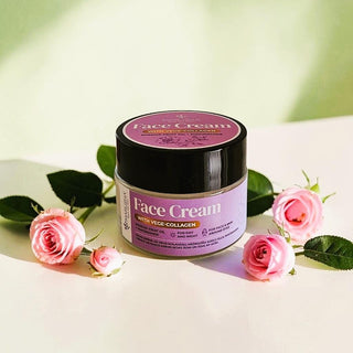 MARUSHA Face Cream with Vege-Collagen sits on a light surface surrounded by pink roses and green leaves