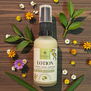 Marusha lotion bottle with flowers and leaves on a wooden background