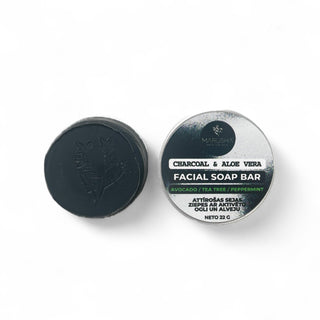 Facial soap bar with charcoal and aloe vera on a white background